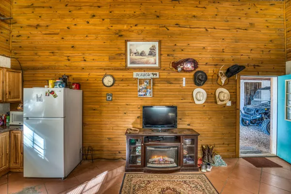 a living room with stainless steel appliances and furniture