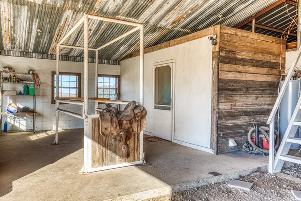 a view of a porch with a table and chairs