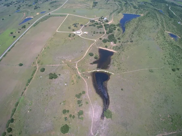 an aerial view of a house with a yard