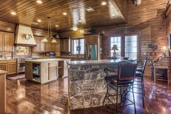 a kitchen with stainless steel appliances granite countertop a stove sink and cabinets