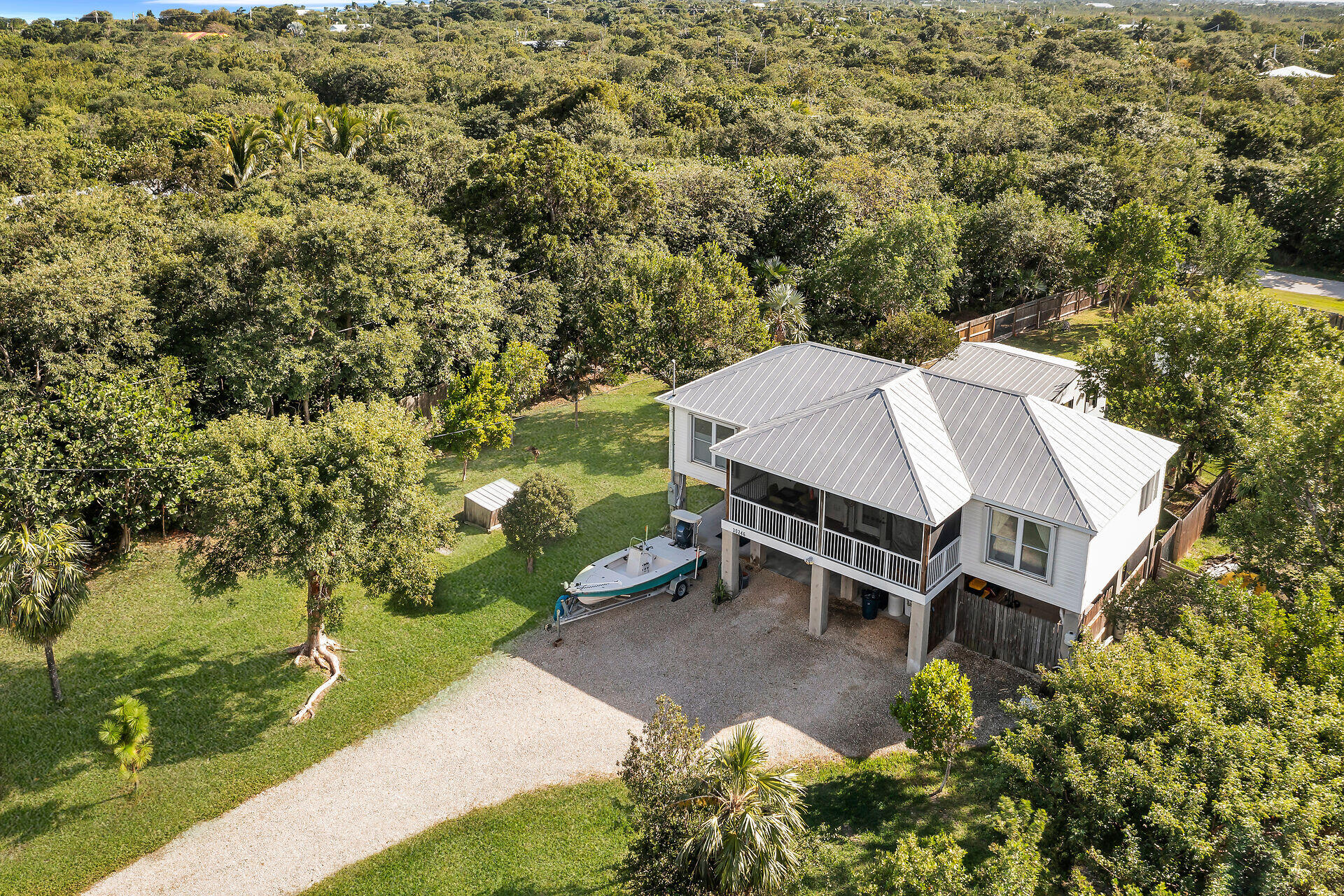 an aerial view of a house with yard and outdoor seating