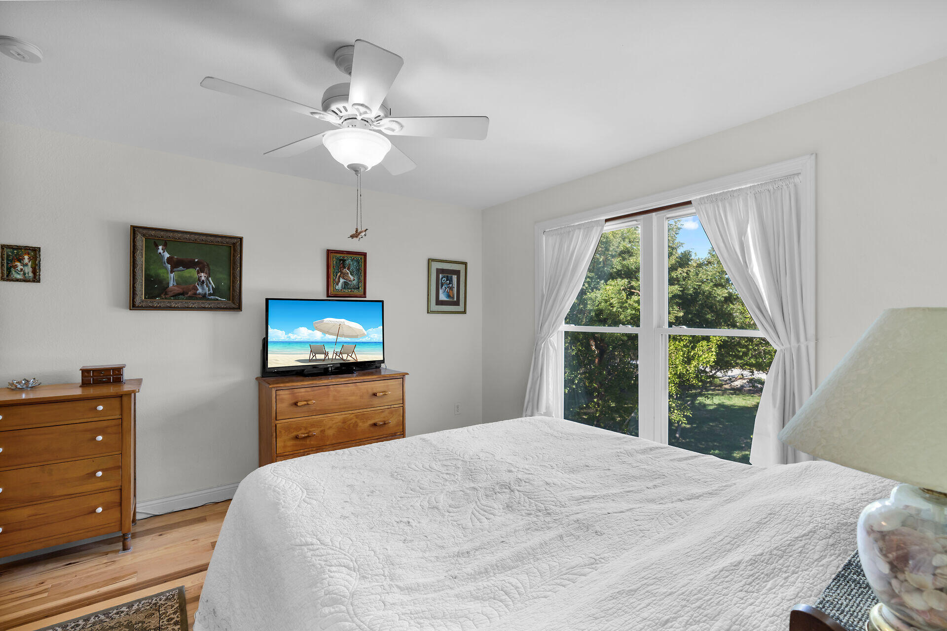 30246 Watson Boulevard Big Pine Key, FL 33043 - Photo 15 of 48 a bedroom with a bed and a flat tv screen on dresser