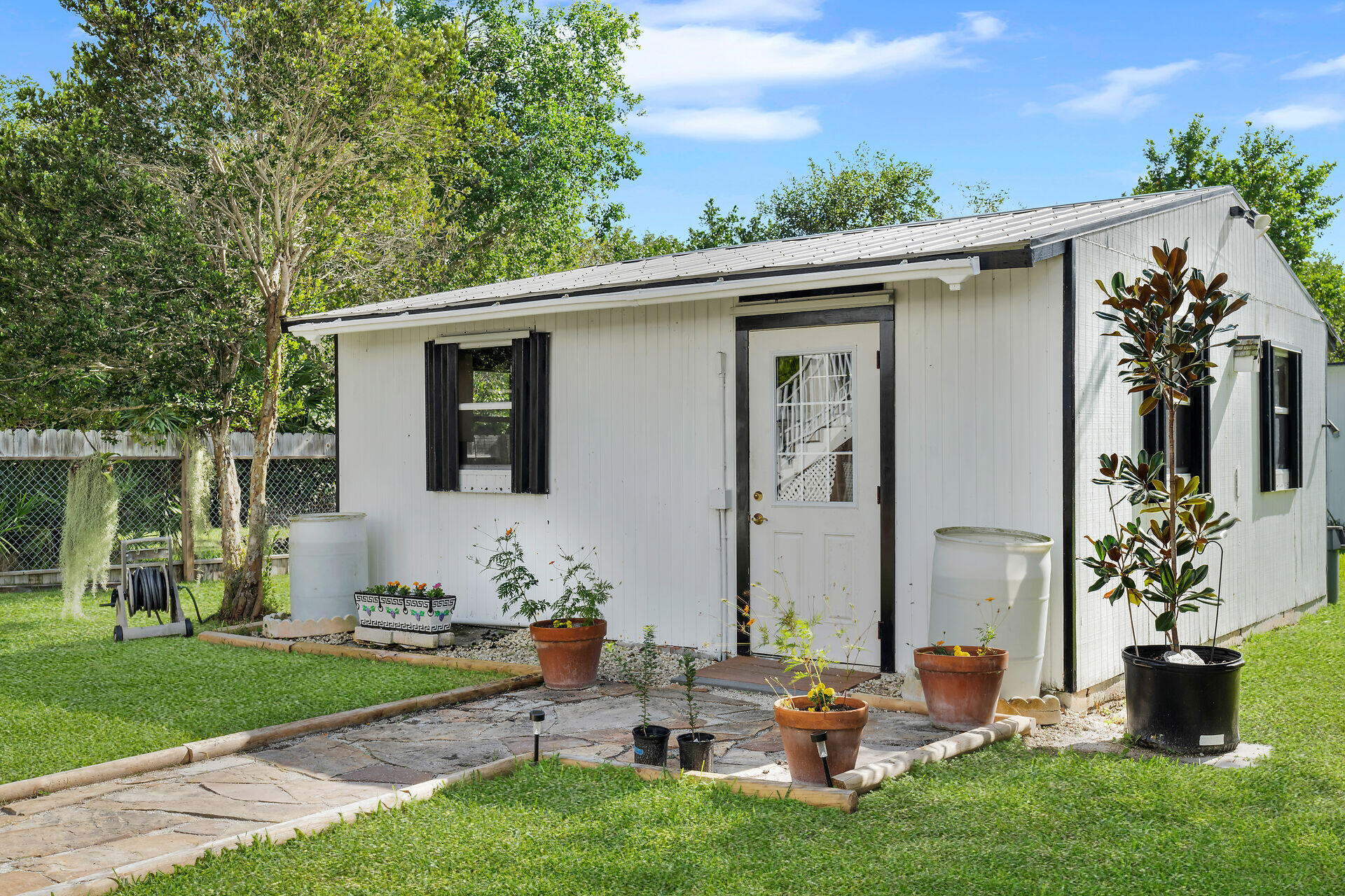 30246 Watson Boulevard Big Pine Key, FL 33043 - Photo 21 of 48 a backyard of a house with table and chairs