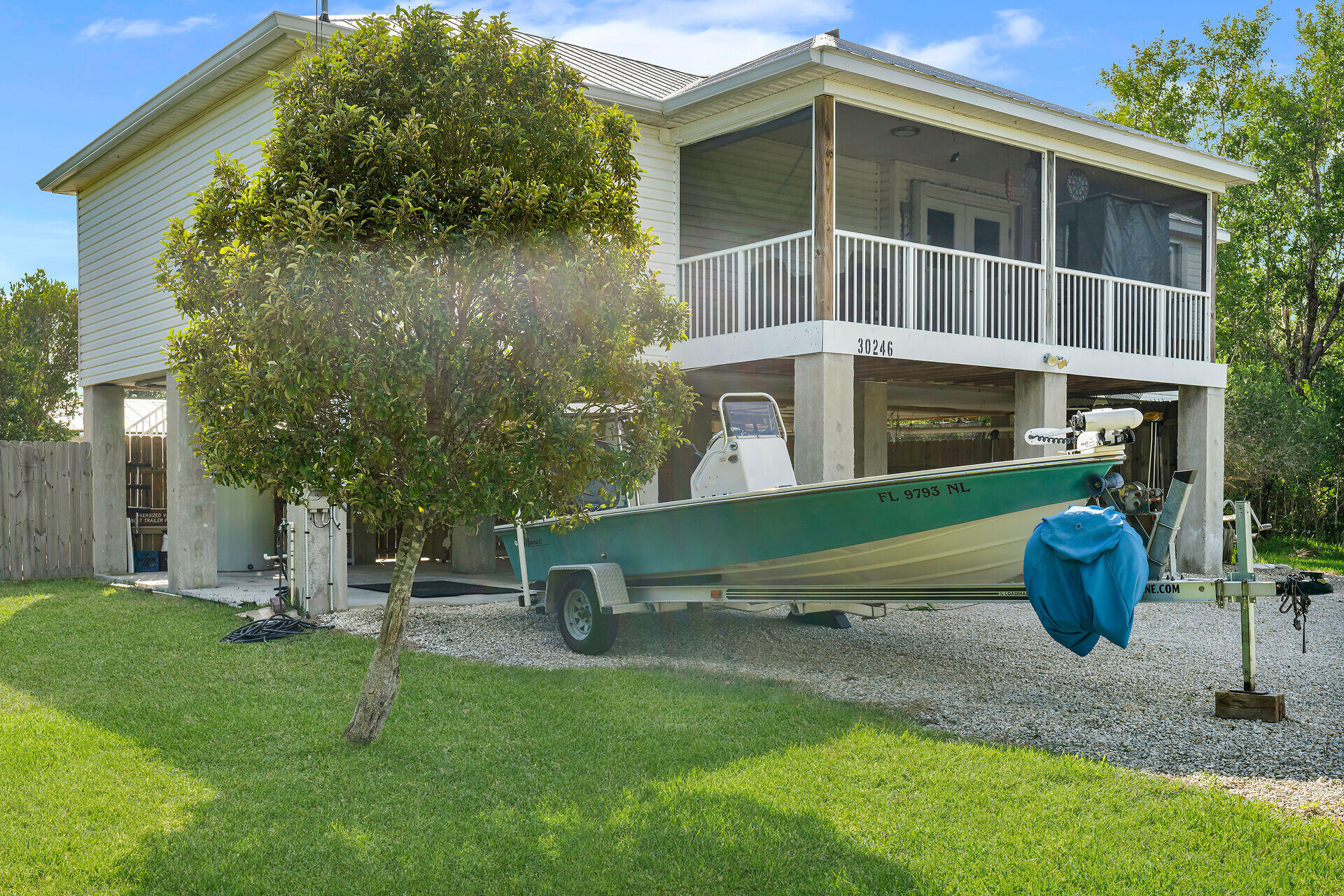 30246 Watson Boulevard Big Pine Key, FL 33043 - Photo 37 of 48 a blue bench sitting in front of a house