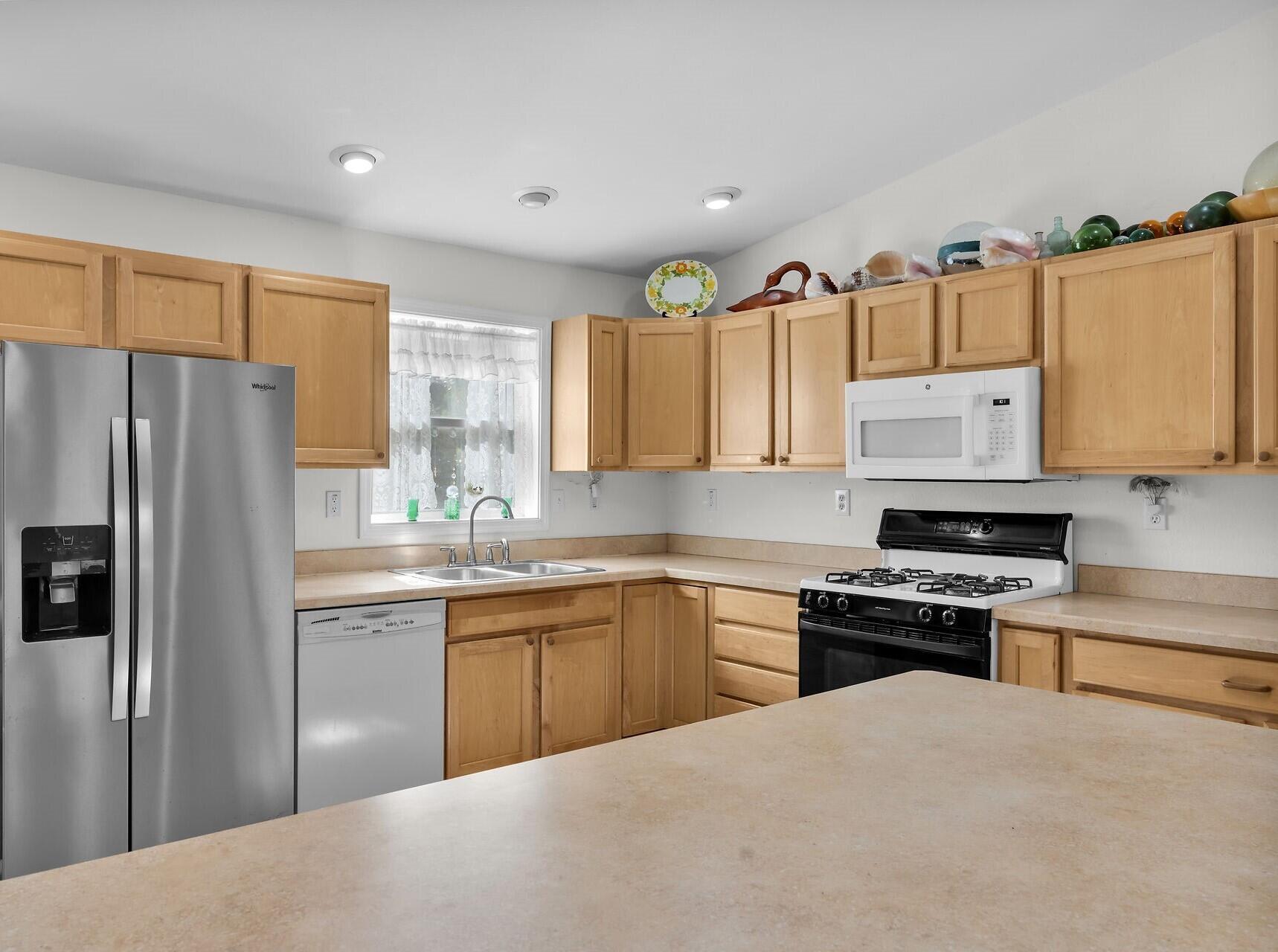 30246 Watson Boulevard Big Pine Key, FL 33043 - Photo 7 of 48 a kitchen with stainless steel appliances granite countertop a stove a sink and a refrigerator