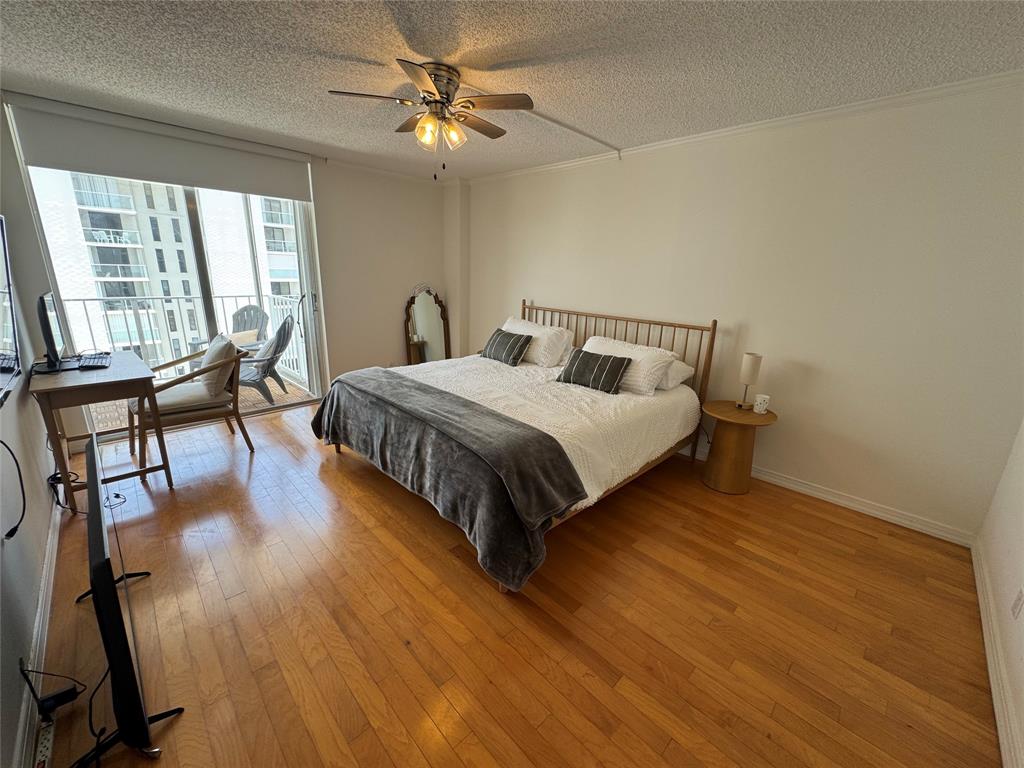 1010 South Ocean Boulevard, Unit 1612 Pompano Beach, FL 33062 - Photo 11 of 35 a bedroom with a bed a chandelier and next to a window