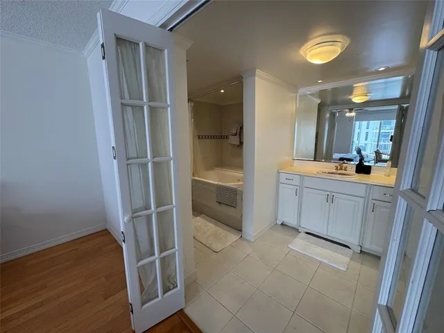 a bathroom with a vanity a sink a mirror and a shower