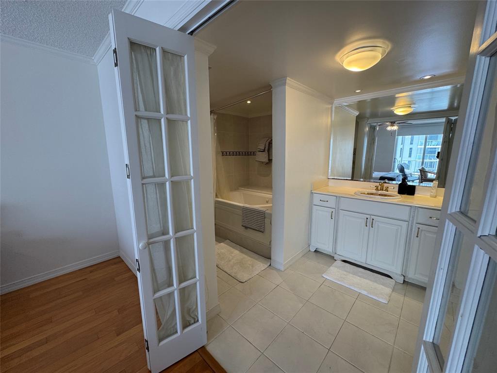 1010 South Ocean Boulevard, Unit 1612 Pompano Beach, FL 33062 - Photo 13 of 35 a bathroom with a vanity a sink a mirror and a shower