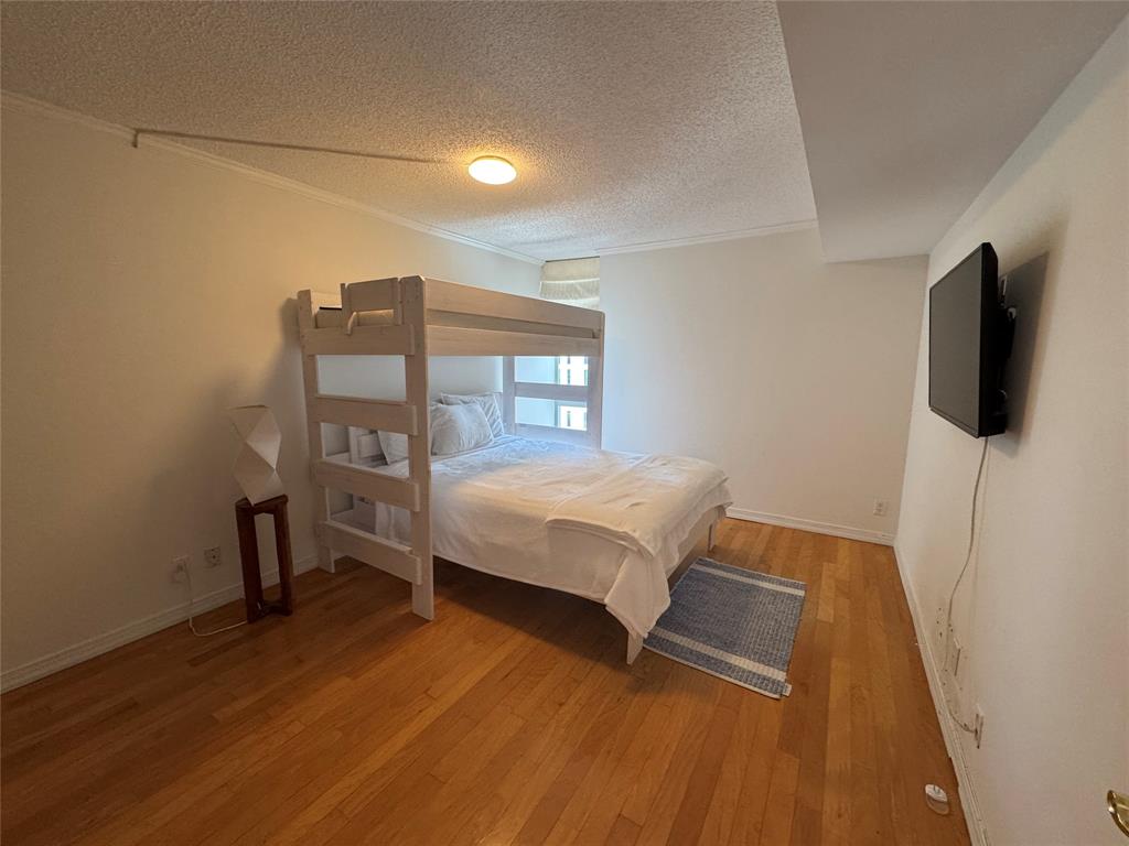 1010 South Ocean Boulevard, Unit 1612 Pompano Beach, FL 33062 - Photo 17 of 35 a bedroom with a bed and flat tv screen on wall