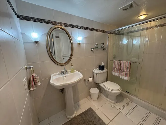 a bathroom with a sink toilet and a mirror