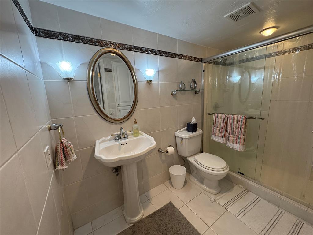 1010 South Ocean Boulevard, Unit 1612 Pompano Beach, FL 33062 - Photo 19 of 35 a bathroom with a sink toilet and a mirror