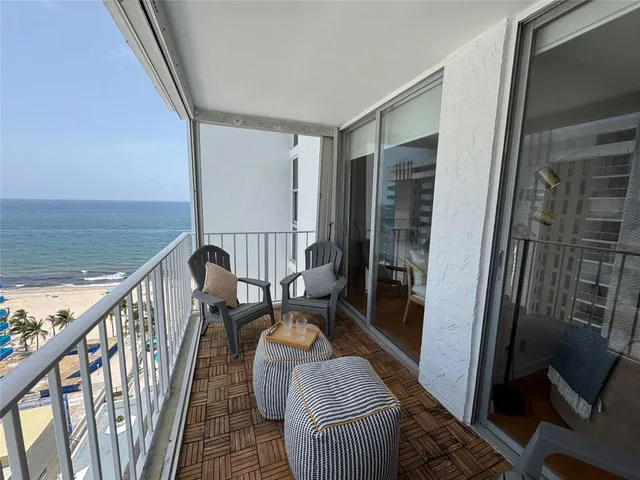 a balcony view with a couch and wooden floor