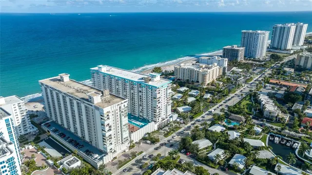 a living room with furniture a large window and a chandelier