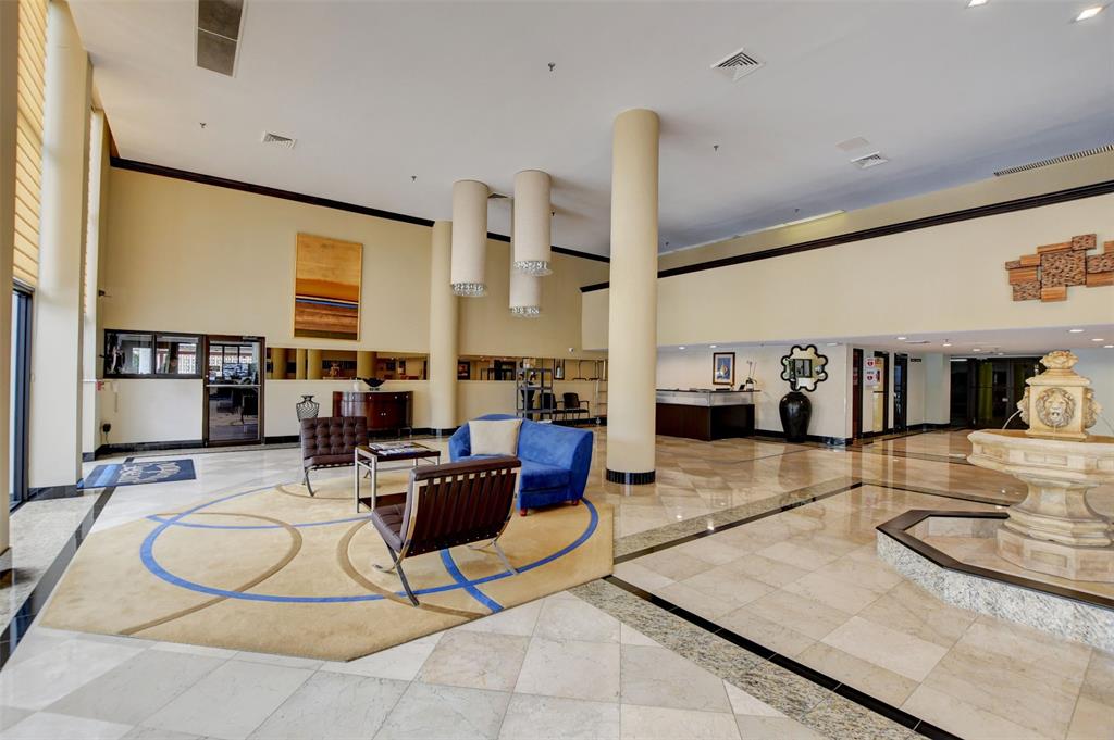 1010 South Ocean Boulevard, Unit 1612 Pompano Beach, FL 33062 - Photo 28 of 35 a living room with furniture a large window and a chandelier