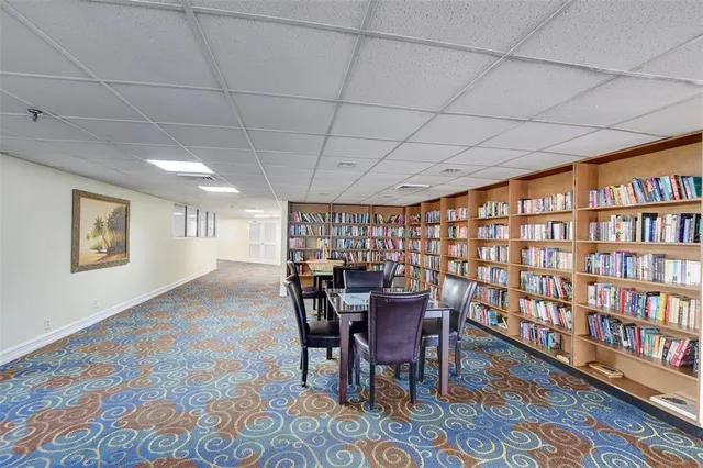 a room with pool table and windows