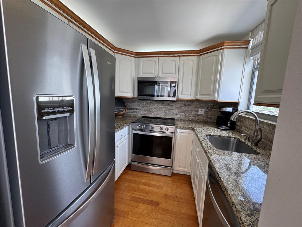 1010 South Ocean Boulevard, Unit 1612 Pompano Beach, FL 33062 - Photo 9 of 35 a kitchen with granite countertop a refrigerator stove and sink