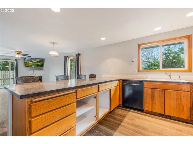 a kitchen with stainless steel appliances granite countertop a sink and cabinets