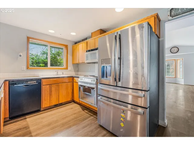 a kitchen with stainless steel appliances a refrigerator sink and cabinets