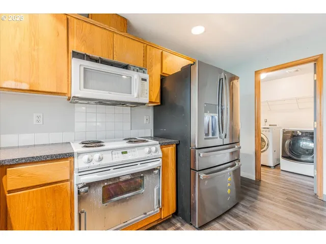 a kitchen with a stove a sink and a refrigerator