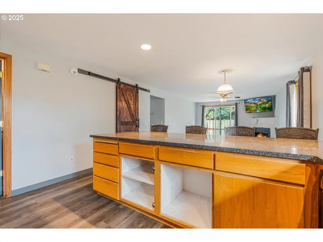 a kitchen with stainless steel appliances granite countertop a sink and a wooden cabinets
