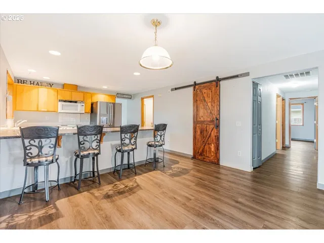 a view of a dining room with furniture and wooden floor