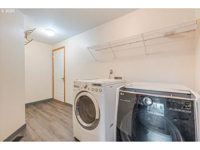 a view of storage and utility room with washer and dryer