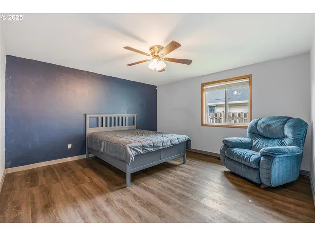 a bedroom with a bed couch and window