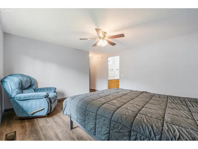 a bedroom with a bed and a couch