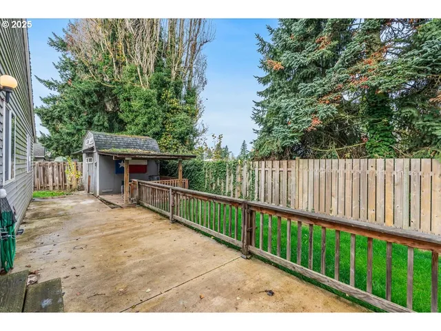a view of house with backyard and sitting area