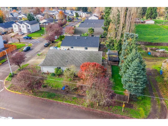 an aerial view of a houses with a yard