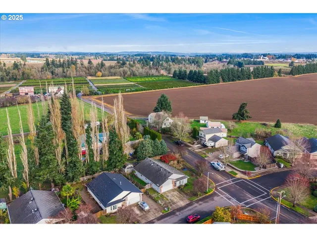 an aerial view of a house with a yard basket ball court and outdoor seating