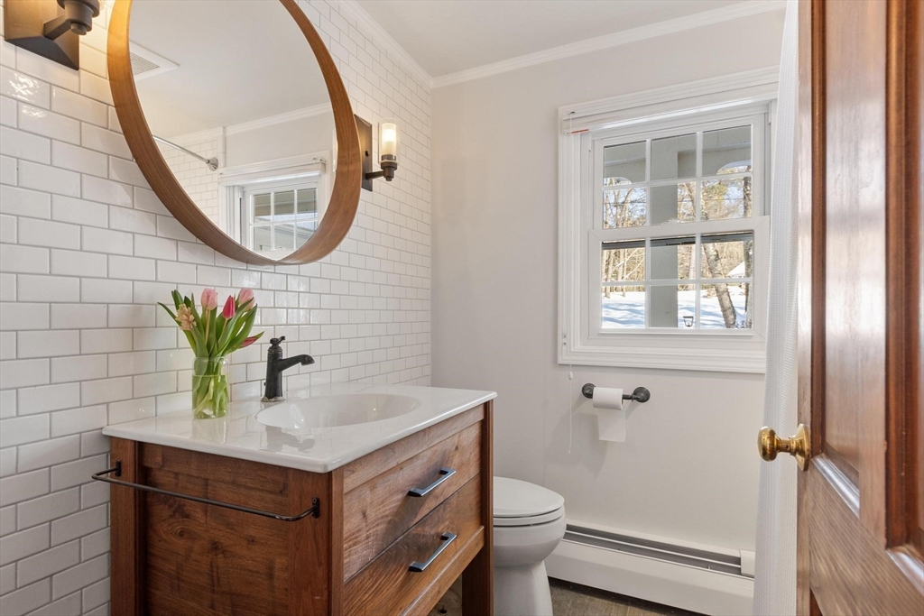 54 Birch Road Andover, MA 01810 - Photo 18 of 37 a bathroom with a sink mirror and a toilet