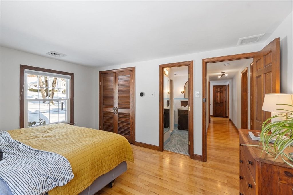 54 Birch Road Andover, MA 01810 - Photo 19 of 37 a bedroom with a bed and glass door