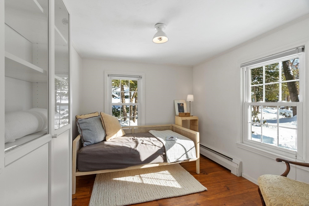 54 Birch Road Andover, MA 01810 - Photo 29 of 37 a bedroom with a bed and wooden floor