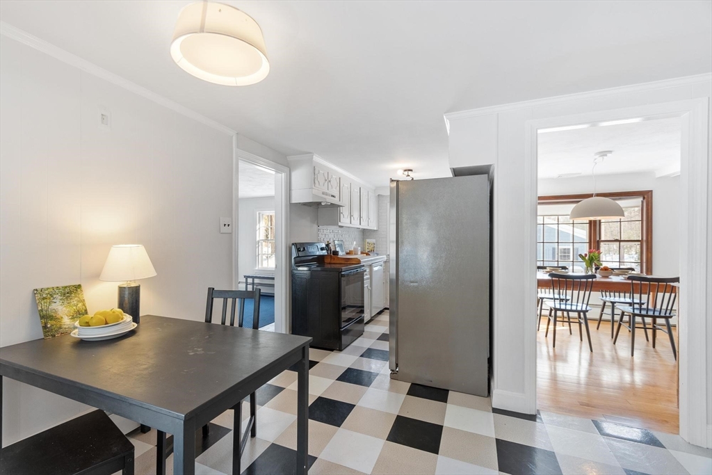 54 Birch Road Andover, MA 01810 - Photo 10 of 37 a kitchen with a table chairs refrigerator and microwave