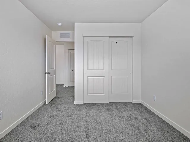 an empty room with closet area