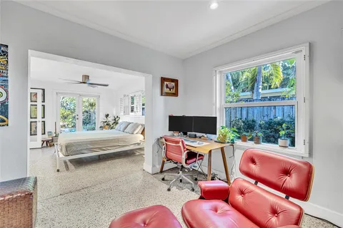 a bedroom with furniture and a window