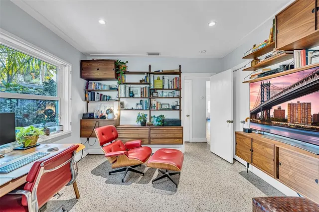 a living room with furniture a window and bookshelf