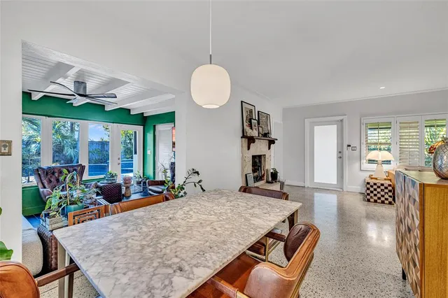 a living room with furniture dining table and a large window