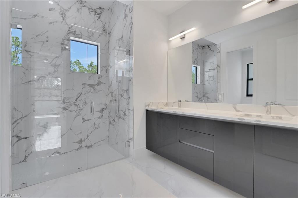 3780 6th Avenue Southeast Naples, FL 34117 - Photo 19 of 33 a bathroom with a double vanity sink mirror and shower
