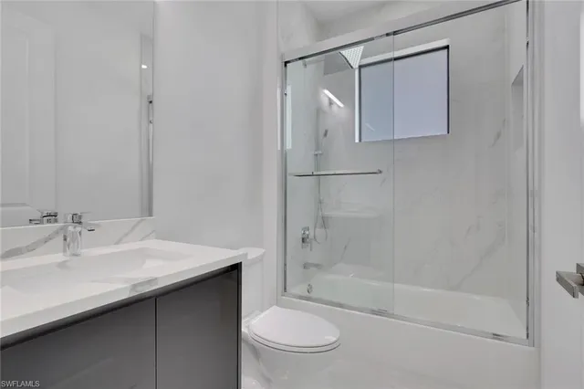 an empty room with a ceiling fan and a window