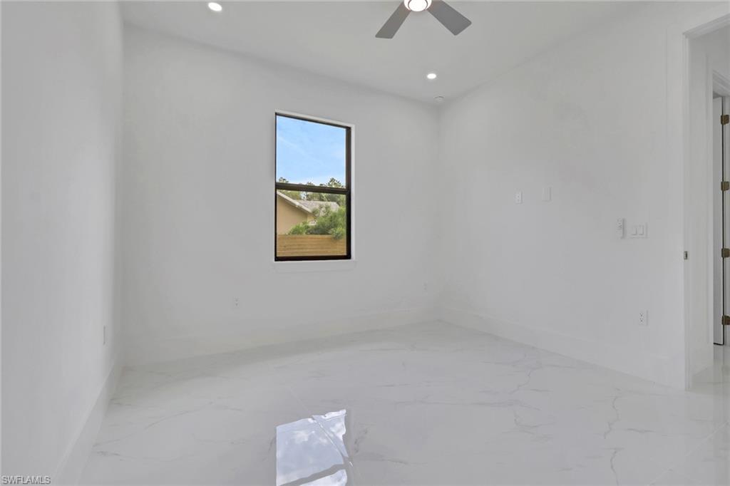 3780 6th Avenue Southeast Naples, FL 34117 - Photo 24 of 33 an empty room with a ceiling fan and a window