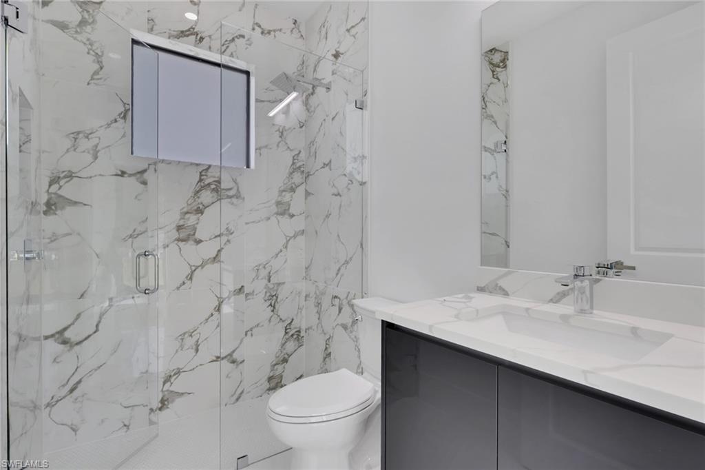 3780 6th Avenue Southeast Naples, FL 34117 - Photo 26 of 33 a bathroom with a sink toilet and shower
