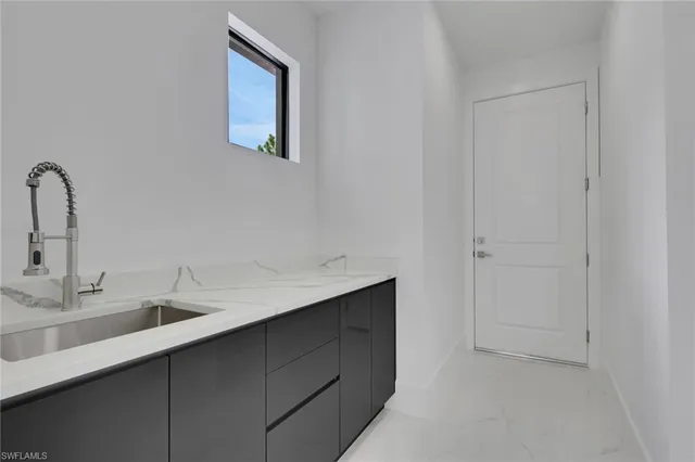 a view of a backyard with potted plants and floor to ceiling window