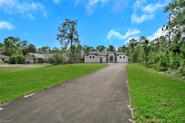 a view of a garden with a building in the background