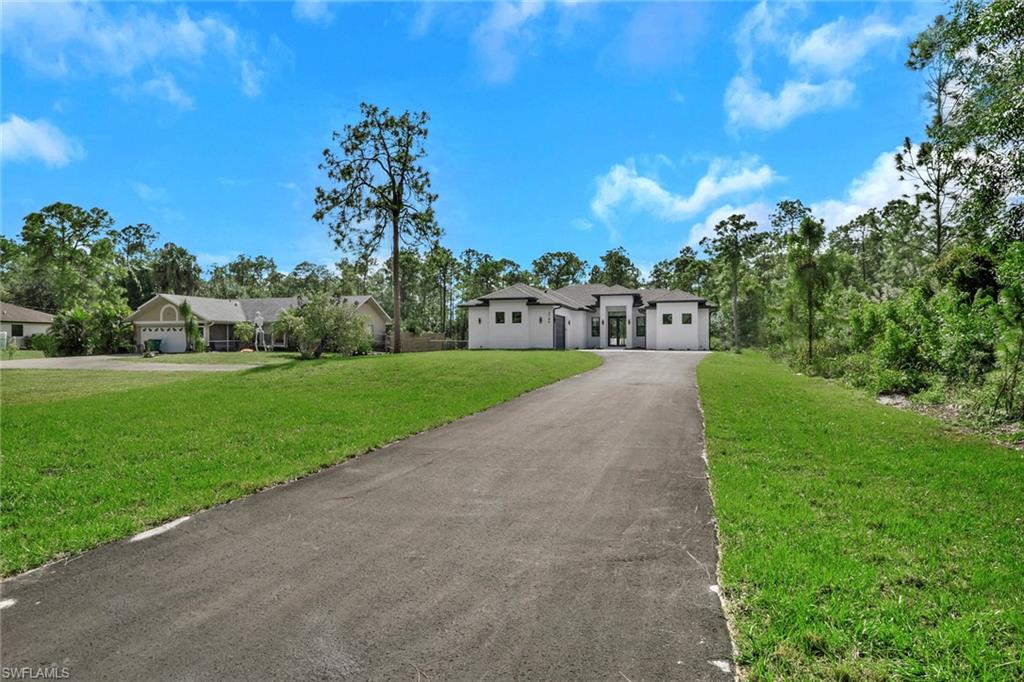 3780 6th Avenue Southeast Naples, FL 34117 - Photo 3 of 33 a view of a garden with a building in the background
