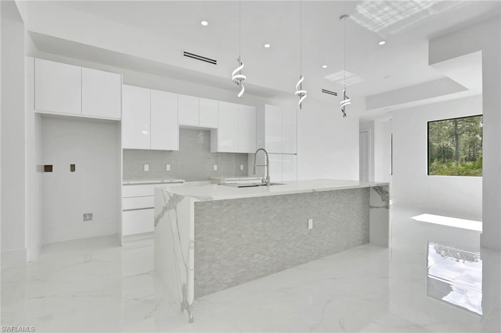 3780 6th Avenue Southeast Naples, FL 34117 - Photo 9 of 33 a large kitchen with cabinets