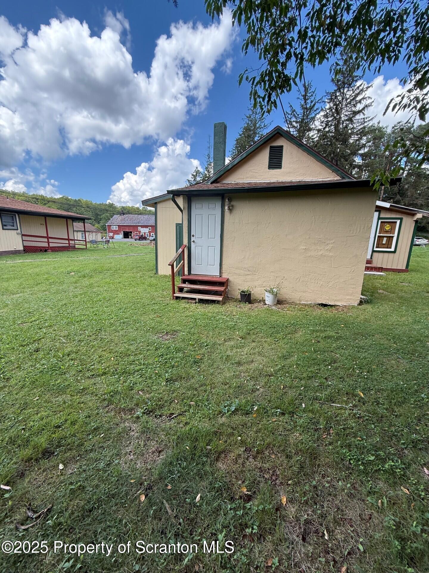 35 Keystone Road, Unit 4 MAPLE Gouldsboro, PA 18424 - Photo 2 of 10 a front view of a house with a yard