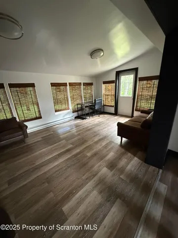 a view of a livingroom with furniture and windows