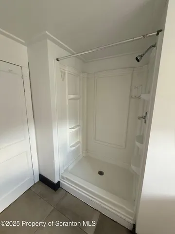 a bathroom with a glass shower door